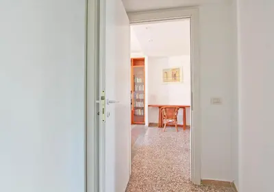 a hallway with a door leading to a dining room at Julia Apartment in Rome