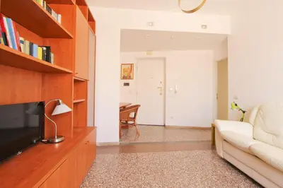 a living room with a couch and a television at Julia Apartment in Rome