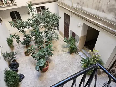 an indoor courtyard with potted plants in a building at Raggio di Sole in Rome