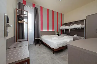 a small room with a bed and bunk beds at Termini Comfort Rooms and Jacuzzi Suite by Flatinrome in Rome