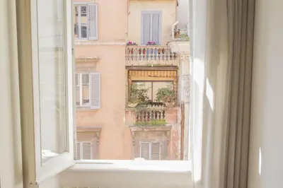 an open window with a view of a building at Sistina 138 Luxury Home in Rome