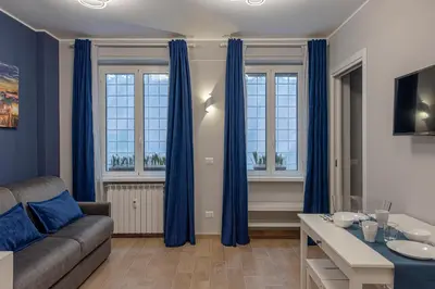 a living room with blue curtains and a couch at GoldStar apartments in Rome