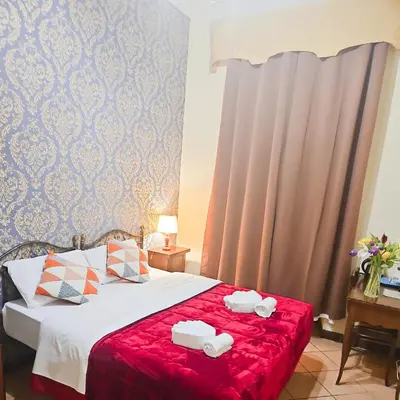 a bedroom with a bed with two towels on it at Hotel Giubileo in Rome