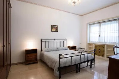 a bedroom with a bed and two night stands and a window at Casa NeLLa, Apartment with 2 bedrooms, Rome in Rome