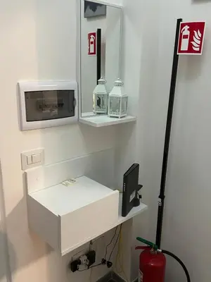 a room with a white desk with a microwave and a tv at San Giovanni Studio in Rome