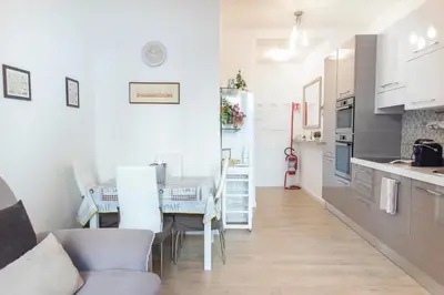 a kitchen and dining room with a table and chairs at Sidama Boutique Stay in Rome