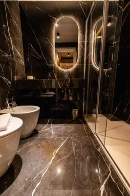 a bathroom with two sinks and a mirror at Whim Collection Trastevere in Rome