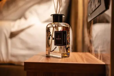 a bottle of perfume sitting on a wooden table at Whim Collection Trastevere in Rome