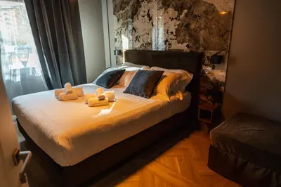 a bedroom with a bed with two towels on it at Whim Collection Trastevere in Rome