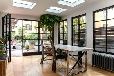 a dining room with a table and chairs and windows at Terrazza segreta del Vaticano in Rome