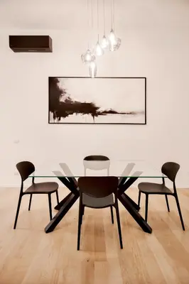 a dining room with a glass table and four chairs at Appartamento Roma Sallustiano in Rome