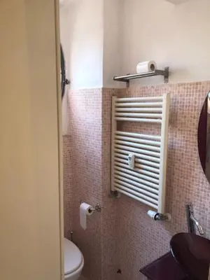 a bathroom with a toilet and a window in it at Mattia Home in Rome