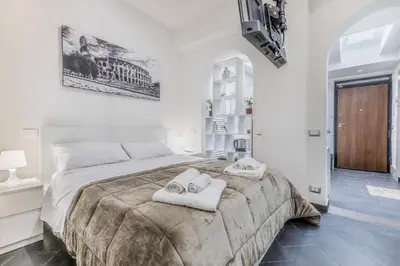 a bedroom with a large bed with towels on it at Battistini Sweet House in Rome