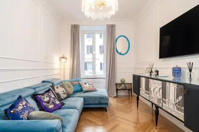 a living room with a blue couch and a tv at Vatican Boutique RHome in Rome