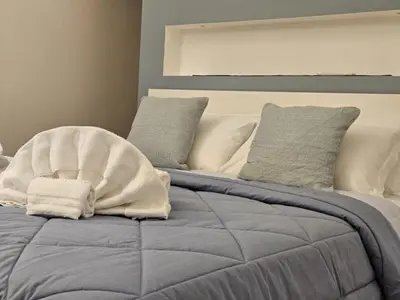 a bed with two towels on top of it at Be Your Home - Casa di Arya in Rome
