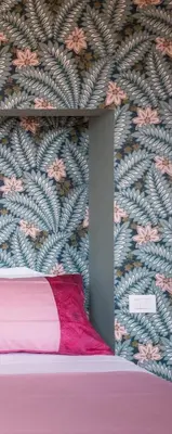 a bedroom with a bed with a floral wallpaper at Terrazze di Venere in Rome