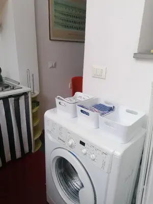 a washing machine with boxes on top of it at All'angolo di San Pietro - wifi in Rome