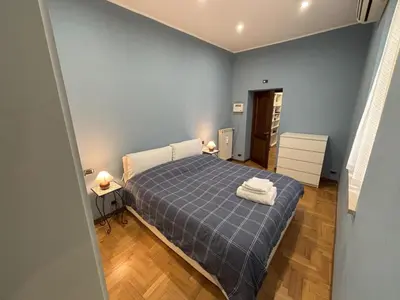 a small bedroom with a bed with a blue blanket at Ai Quattro Cantoni in Rome