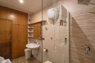 a living room with a white couch and shelves at Casa del Koala al Gemelli Hospital in Rome