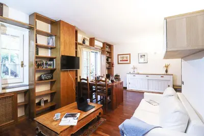 a living room with a white couch and a table at Casa del Koala al Gemelli Hospital in Rome