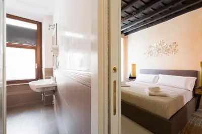 a small bedroom with a bed and a sink at Trinità Dei Monti in Rome