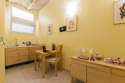 a kitchen with a sink and a table with a laptop at Trinità Dei Monti in Rome
