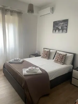 a bedroom with a bed with two towels on it at Pineta Domus in Rome