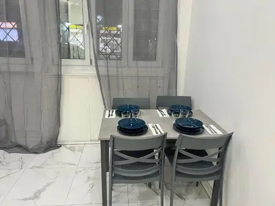 a table with two chairs and blue dishes on it at Casa Justa Gregorio VII in Rome