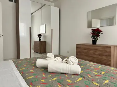 a bedroom with a bed with towels on it at Casa Justa Gregorio VII in Rome