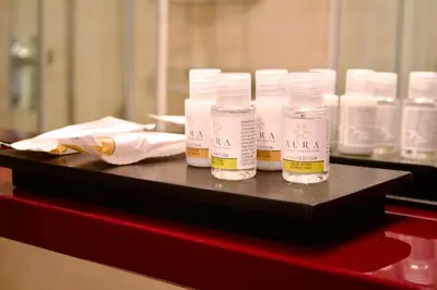 four bottles of moisturizers sitting on a red table at Casa Tigrè in Rome