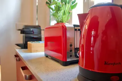 a red toaster sitting on top of a counter at Casa Tigrè in Rome
