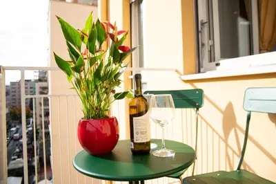 a bottle of wine and a glass and a plant on a table at Casa Tigrè in Rome