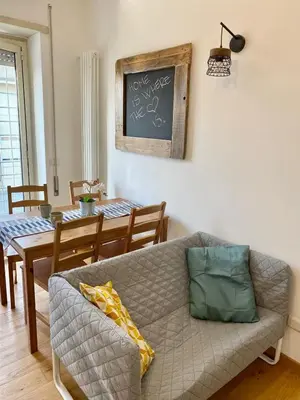 a living room with a couch and a table at Attico con balcone in Rome