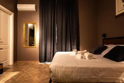 a bedroom with a bed with two towels on it at Whim Collection Vaticano Pra ti in Rome