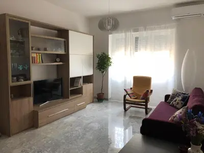 a living room with a couch and a tv at Casa Salù in Rome