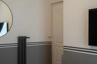 a room with a door with blue stripes and a mirror at Castro Pretorio 24 - FromHometoRome in Rome