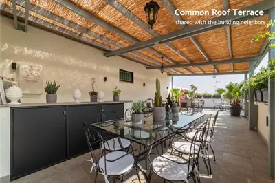 a dining room with a table and chairs on a patio at Castro Pretorio 24 - FromHometoRome in Rome