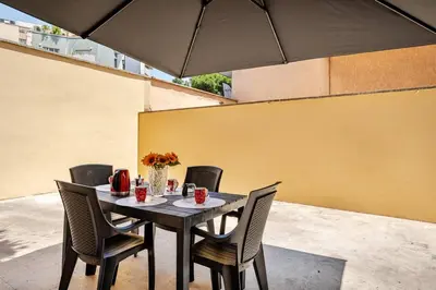 a black table with chairs and a black umbrella at Roma San Pietro - Vatican Vibes apartment in Rome