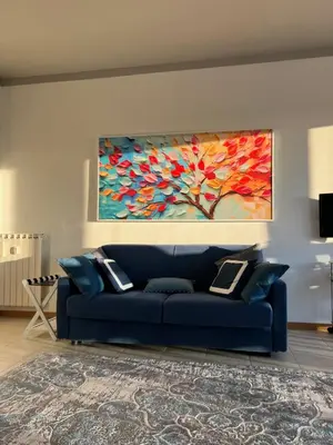 a blue couch in a living room with a painting on the wall at Serendiroma in Rome