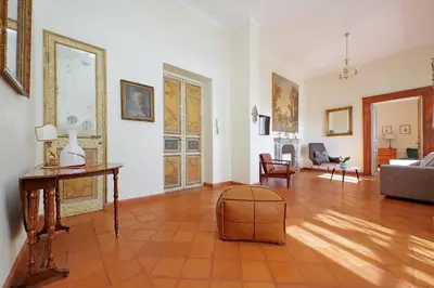 a living room with a couch and a table at Piazza di Spagna Cozy House & Amazing View in Rome