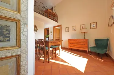a living room and dining room with a table and chairs at Piazza di Spagna Cozy House & Amazing View in Rome