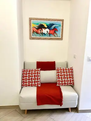 a couch in a room with a painting on the wall at Vacanze Romane at Furio Camillo in Rome