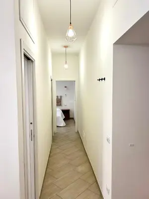 a hallway with a hallway leading to a bedroom at Vacanze Romane at Furio Camillo in Rome