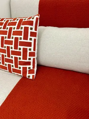 a red and white pillow on a red and white couch at Vacanze Romane at Furio Camillo in Rome