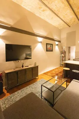 a living room with a large flat screen tv on the wall at Trastevere Spot in Rome