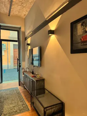 a living room with a tv on a wall at Trastevere Spot in Rome