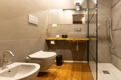 a bathroom with a toilet and a sink and a shower at Trastevere Spot in Rome