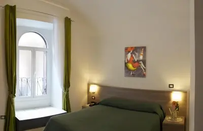 a bedroom with a bed and a window at Termini in Bed in Rome