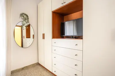 a bedroom with a dresser and a mirror at Espress break in Rome