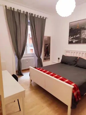 a bedroom with a large bed and a window at Lovely Flat Roma Università in Rome